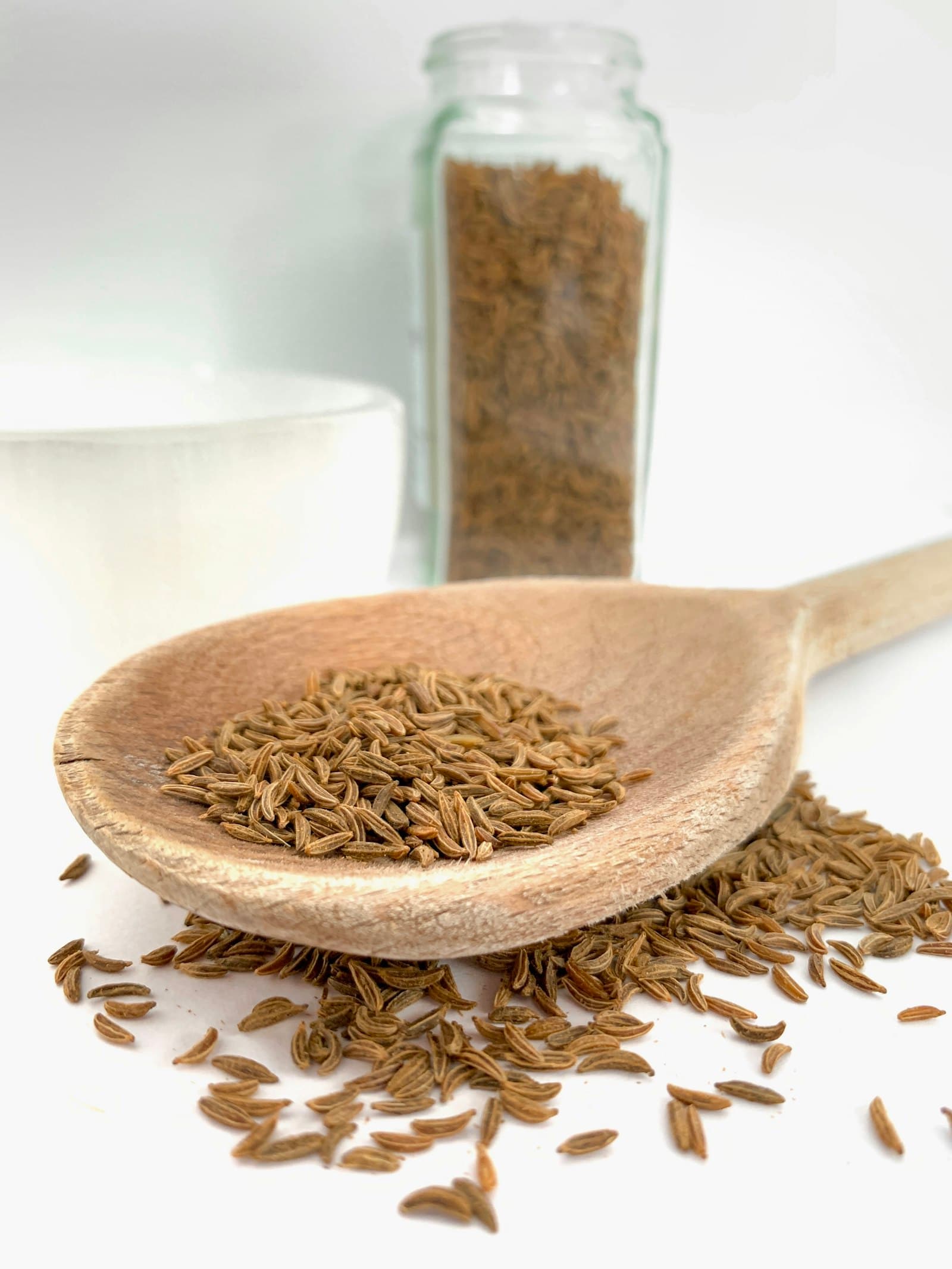 Whole cumin seeds (jeera) in a wooden spoon